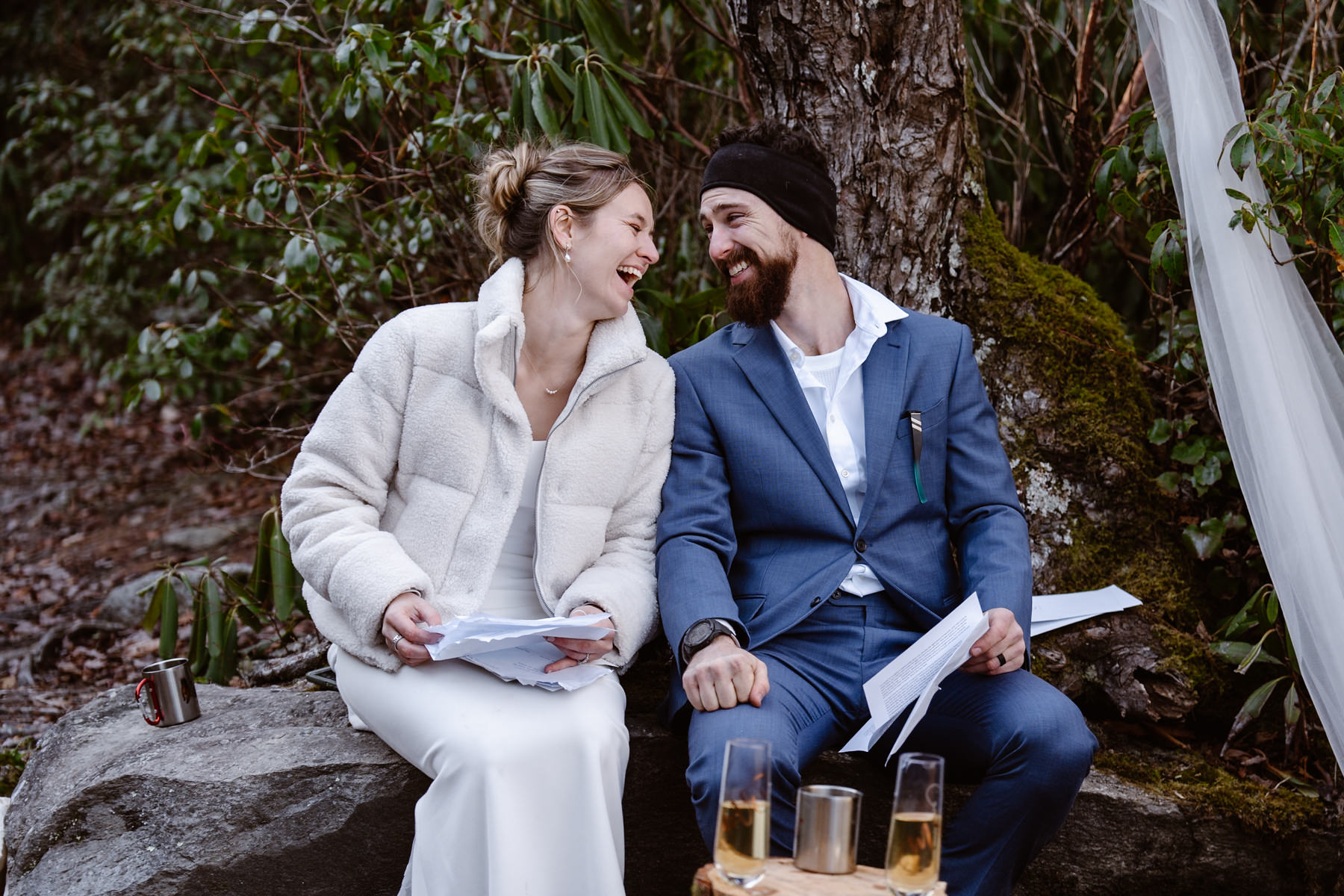 An eloping couple reading letters of well wishes from their family