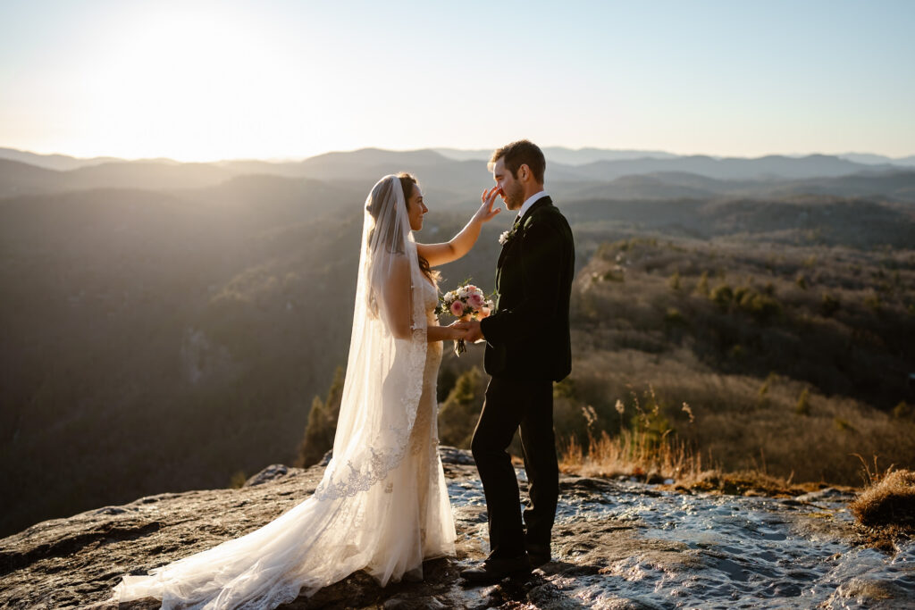 Couple exchanging private vows overlooking the mountains