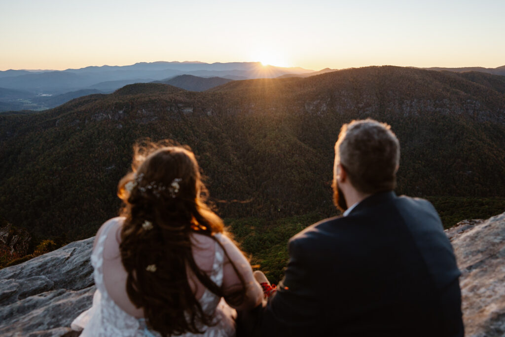 Couple watching a mountain sunset after their elopement near Asheville NC